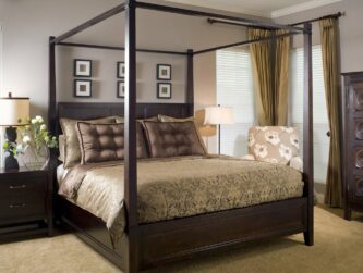 Spacious suite with four post bed, relaxing natural tones, and fresh picked flowers next to the bed