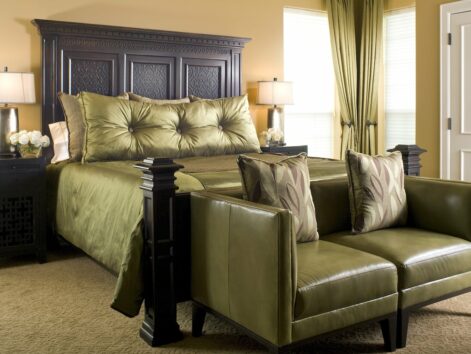 Elegant suite with green silk king bed and green leather loveseat